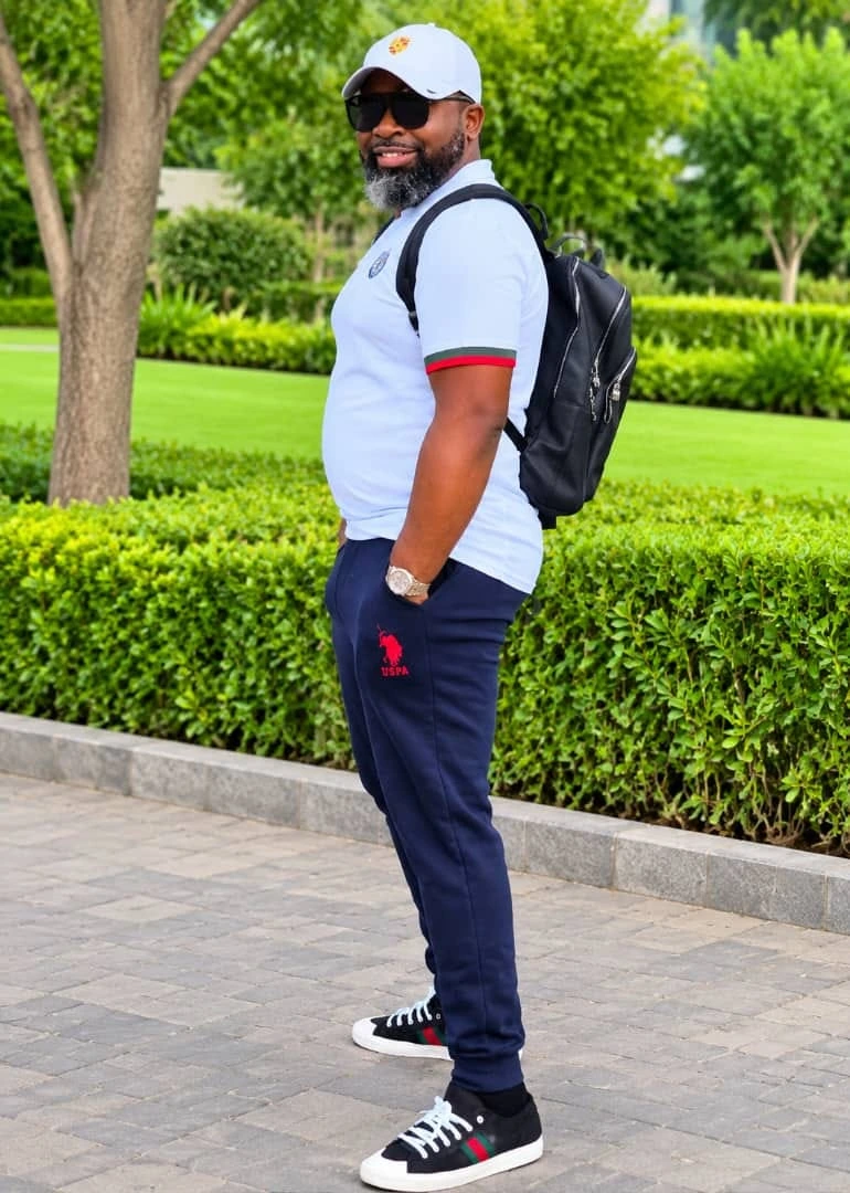 Olukayode enjoying time outdoors in a white polo and cap